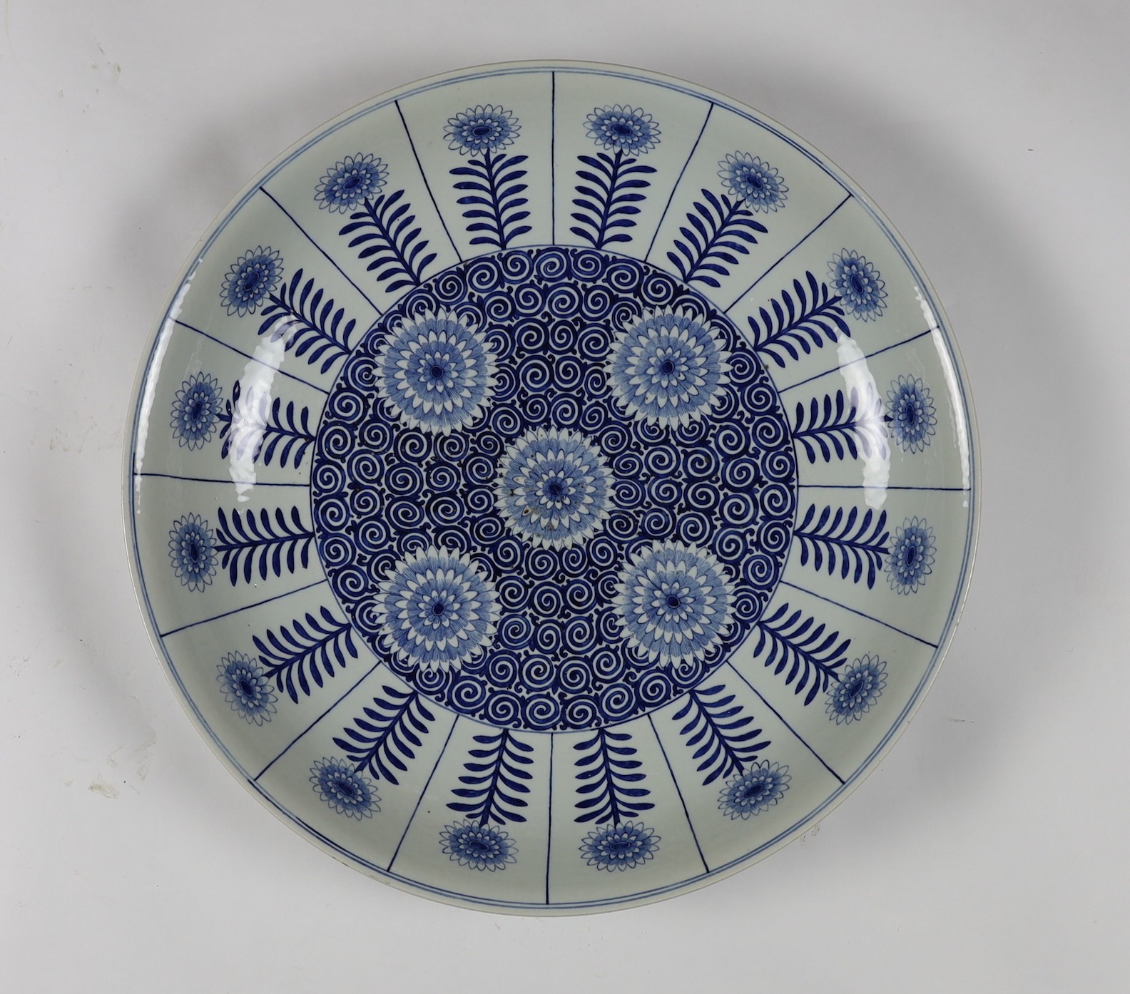 A pair of massive Chinese blue and white Aster pattern dishes, Kangxi mark but Republic period, 54.5cm diameter, one with a small section broken and restuck